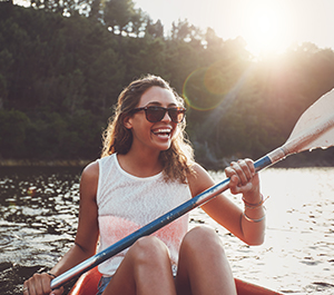 Girl kayaks while doing spring break on a budget