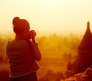 Girl takes a photograph while traveling
