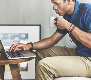 Man practices budgeting basics on his computer